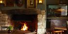 A roaring log fire in the cosy bar, the walls have an eclectic mix of pictures and a taxidermy fish!